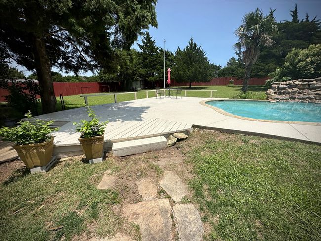 View of pool featuring a wooden deck | Image 4