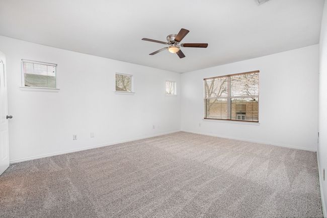 Primary Bedroom featuring baseboards, visible vents, carpet flooring, and a ceiling fan | Image 19