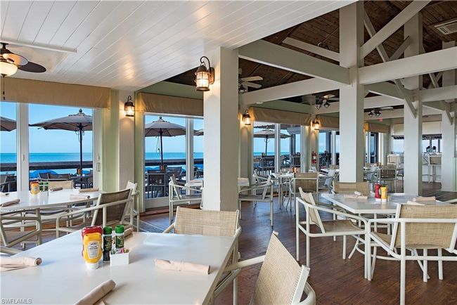 Dining room featuring ceiling fan, dark hardwood / wood-style floors, vaulted ceiling, a water view, and wood ceiling | Image 30