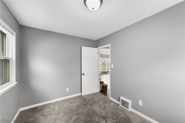 Bedroom with baseboards, visible vents, and carpet floors | Image 15