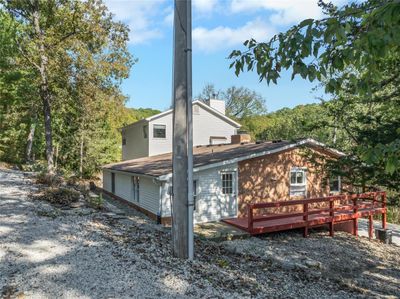 Rear view of house featuring a wooden deck and original portion of home | Image 3