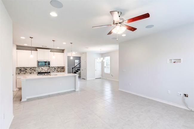 Kitchen featuring appliances with stainless steel finishes, recessed lighting, tasteful backsplash, a ceiling fan, and light countertops | Image 9