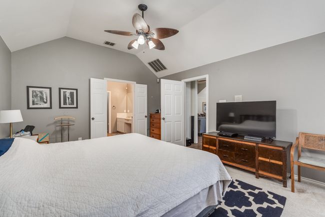 Bedroom featuring lofted ceiling, carpet floors, ceiling fan, and ensuite bath | Image 27