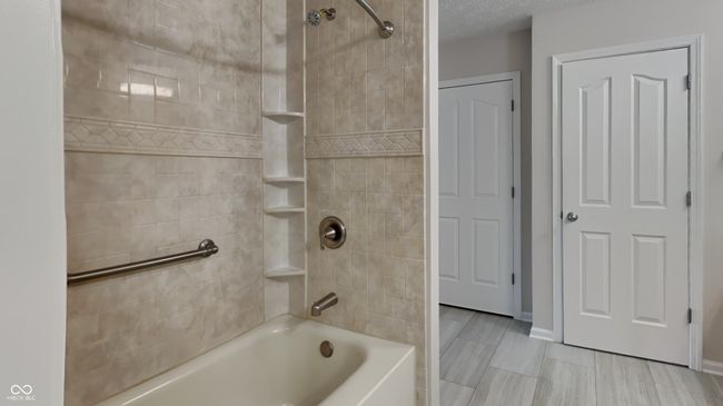full bathroom with shower / bath combination and baseboards | Image 12