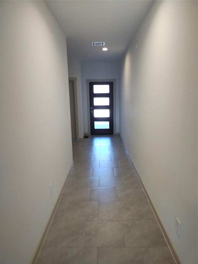 View of hallway looking towards beautiful front door. | Image 17
