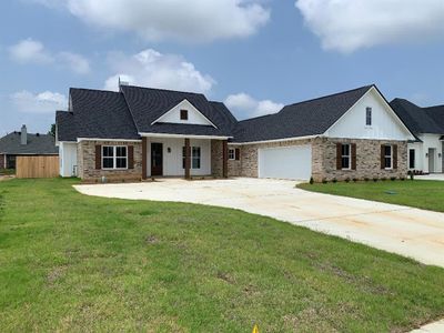 View of front of property with a front yard and a garage | Image 1