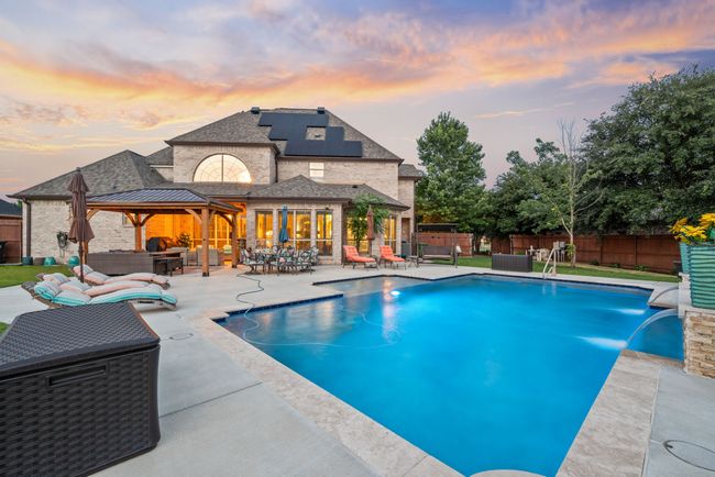 View of swimming pool featuring an outdoor hangout area, a fenced backyard, a patio, a gazebo, and outdoor dining space | Image 5