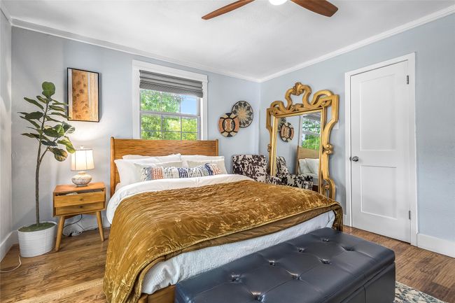 Bedroom featuring crown molding, wood finished floors, baseboards, and a ceiling fan | Image 22