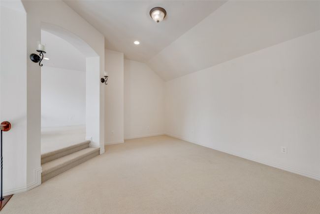 Additional living space with carpet, vaulted ceiling, recessed lighting, and arched walkways | Image 13