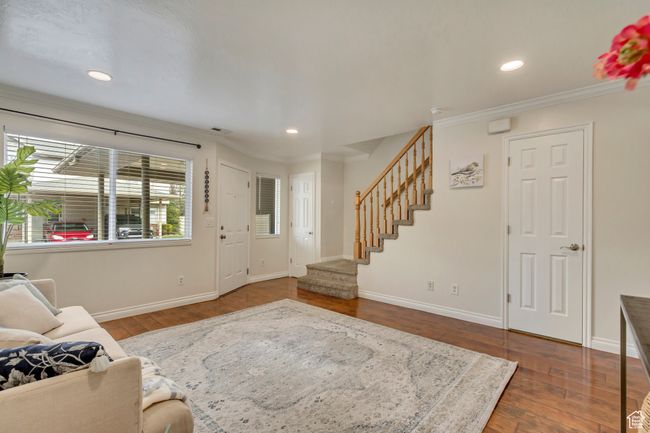 Living area with baseboards, stairway, and hardwood / wood-style flooring | Image 7