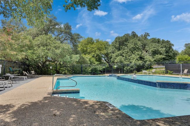 Community pool featuring view of scattered trees and a patio | Image 29