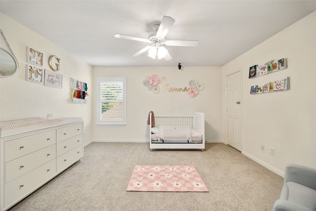 Bedroom featuring baseboards, a ceiling fan, and carpet | Image 20