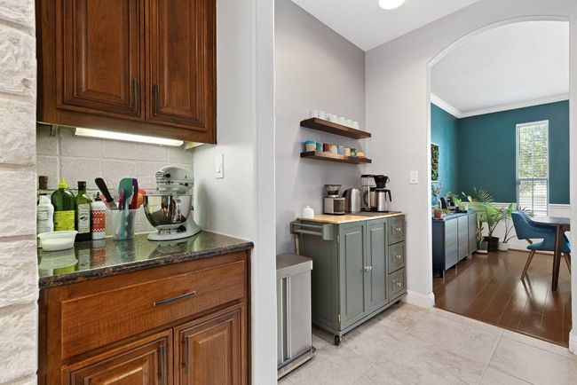 Between the kitchen and formal dining, there is a private space for a counter-top bar and coffee station. Easily accessible for everyday use, but not clearly on display for the whole home to see. | Image 10