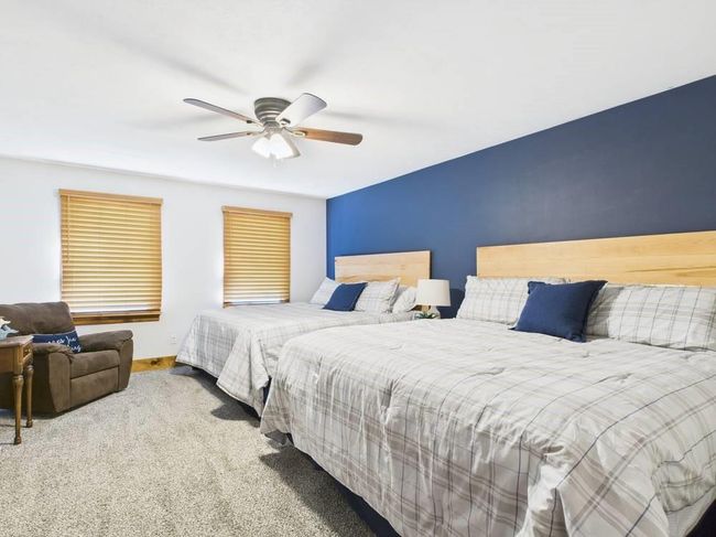 Carpeted primary bedroom with ceiling fan | Image 23