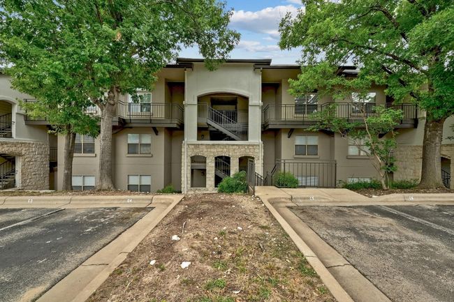View of property featuring uncovered parking | Image 6