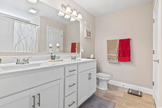 Bathroom featuring toilet and double vanity | Image 25