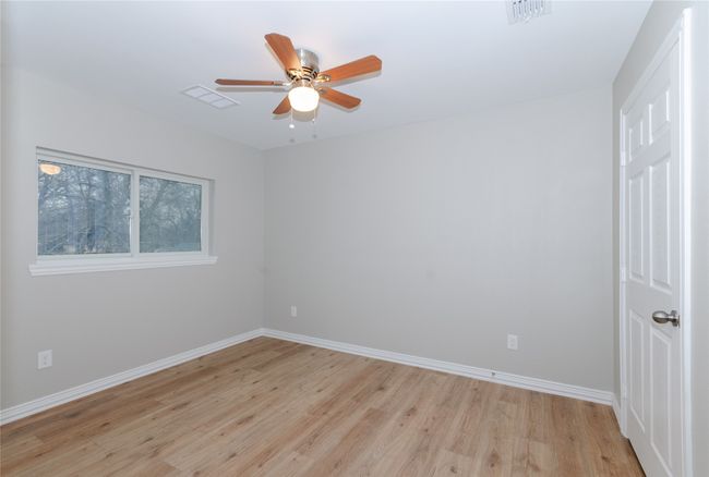 Unfurnished room featuring a ceiling fan, baseboards, visible vents, and light wood finished floors | Image 18