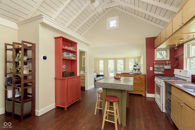 Coming up from the lower level, this is your view! Notice the cathedral ceilings, the open kitchen, and the river view from the sun room. | Image 7