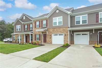 View of property featuring a garage and a front yard | Image 2