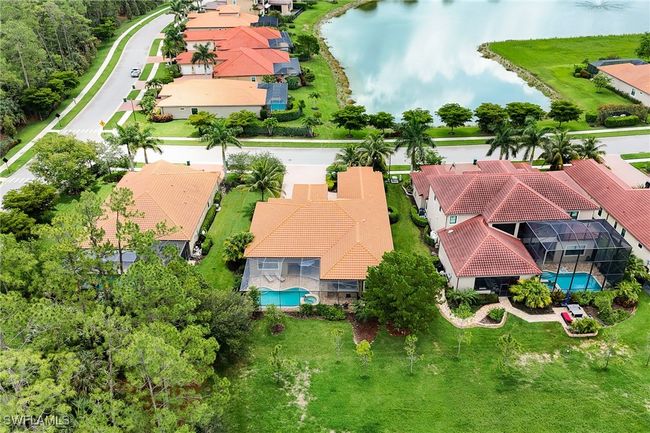 Aerial view of residential area featuring a pool area and a large body of water | Image 44