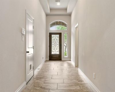 The front door opens into a spacious corridor, setting a welcoming tone as you enter the home. | Image 3