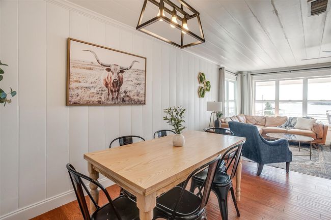 Dining space featuring a chandelier, light wood-type flooring, and crown molding | Image 17