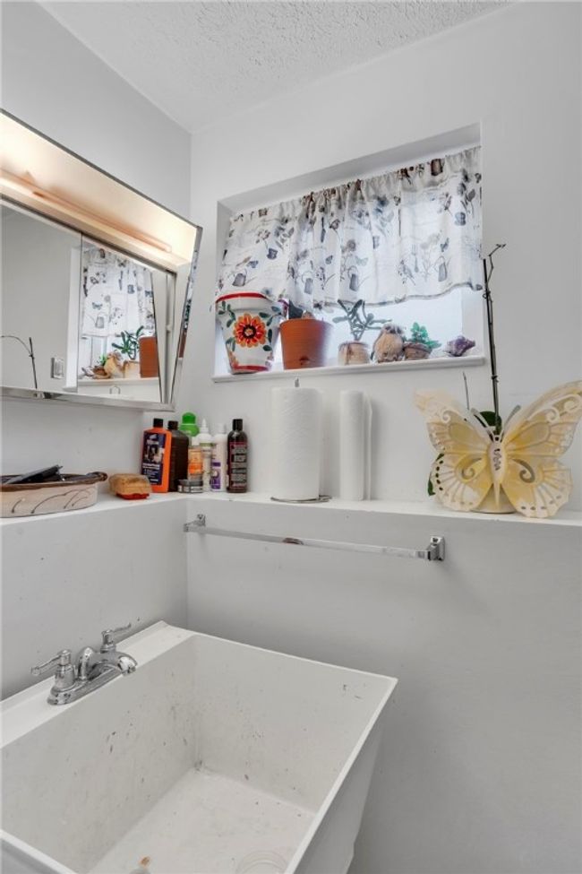 Half bath in basement has a convenient laundry tub and toilet | Image 24
