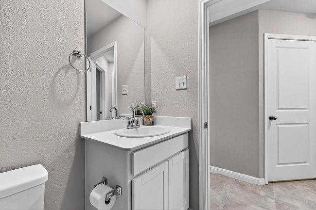 Bathroom featuring vanity and a textured wall | Image 29