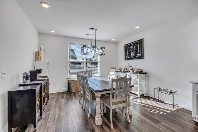 Dining area located next to the kitchen. | Image 7