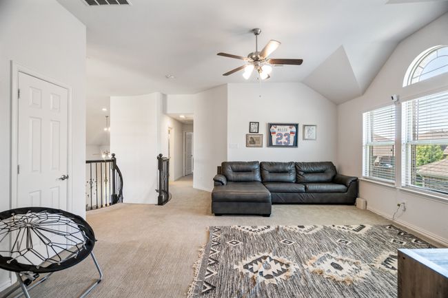 Carpeted living room with a ceiling fan, healthy amount of natural light, and lofted ceiling | Image 24