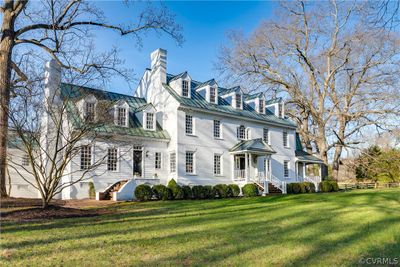 White brick and hardboard exterior with unique copper roof. | Image 3