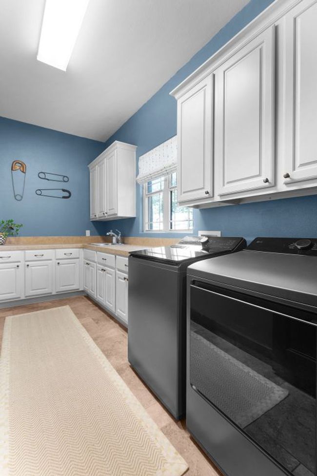 Laundry area featuring cabinet space and separate washer and dryer | Image 27