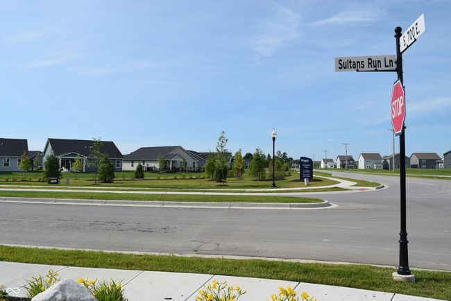 view of entry to Jackson Run with sidewalks, a residential view, curbs, and street lights | Image 38