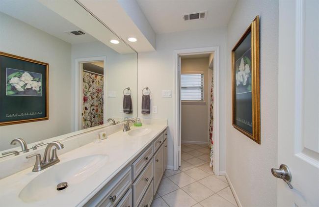The full second bath exudes a relaxing and spa quality atmosphere. With dual sinks and the ability to close off the door to shower area, two bedrooms sharing this bath is easy peasy! | Image 34