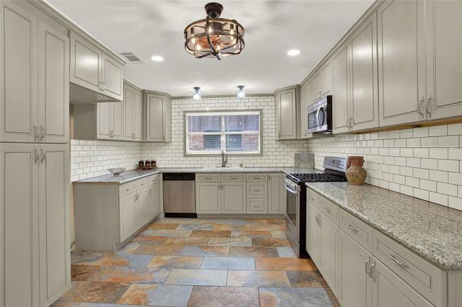 Beautifully remodeled Spacious kitchen shows LED lighting and loads of cabinet space | Image 4