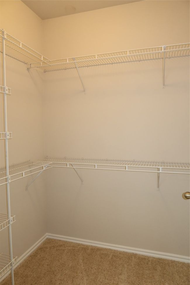 Spacious closet with carpet floors | Image 15