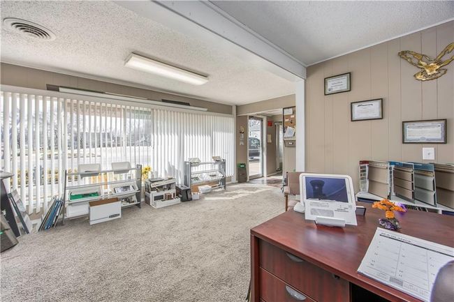 Office featuring visible vents, carpet, and a textured ceiling | Image 24