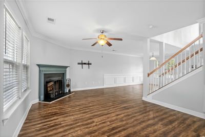 Living room featuring ceiling fan, wood-type flooring, and ornamental molding | Image 3