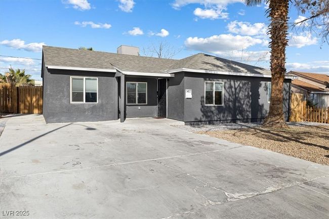 View of front of house with stucco siding, a shingled roof, and fence | Image 5