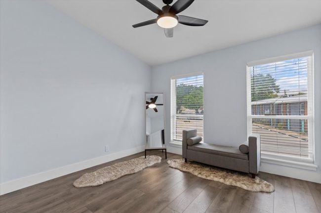 Living area with a ceiling fan, wood finished floors, and lofted ceiling | Image 18