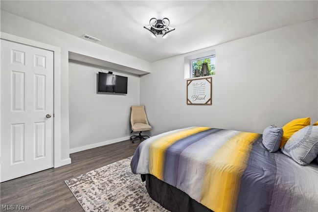 Bedroom with dark wood-type flooring | Image 39