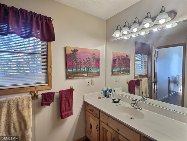The upper level includes a walk-thru bathroom with a door to the primary bedroom and a door to the hallway. | Image 22