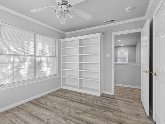 2nd floor bedroom with plenty of natural light, built in cabinets, ceiling fan & laminated floors | Image 27