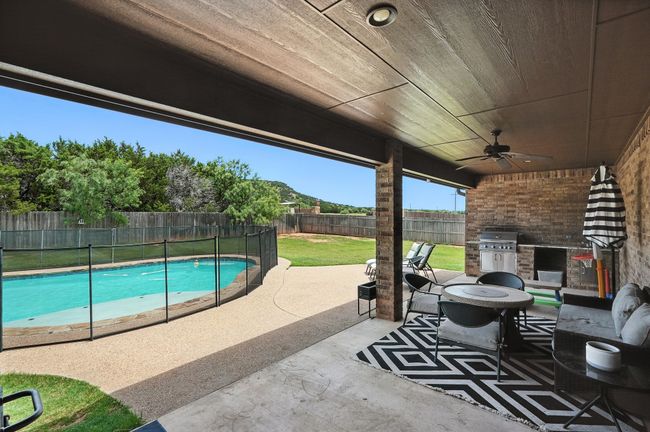Fenced backyard featuring a patio, a ceiling fan, and area for grilling | Image 29
