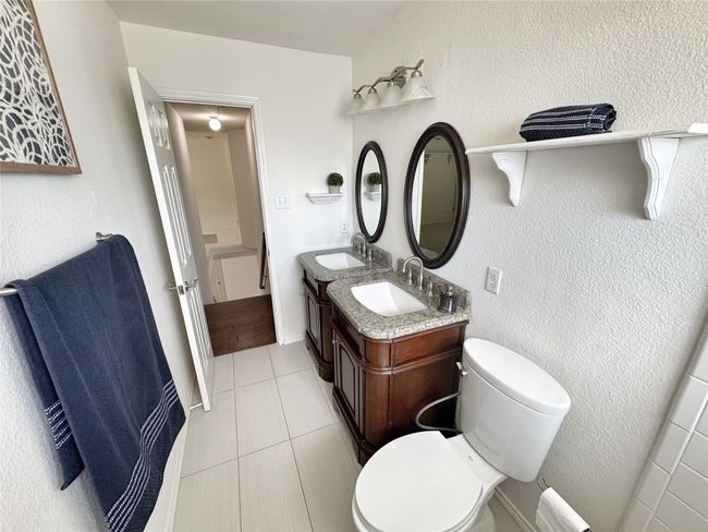 Bathroom with tile patterned floors and double vanity | Image 29