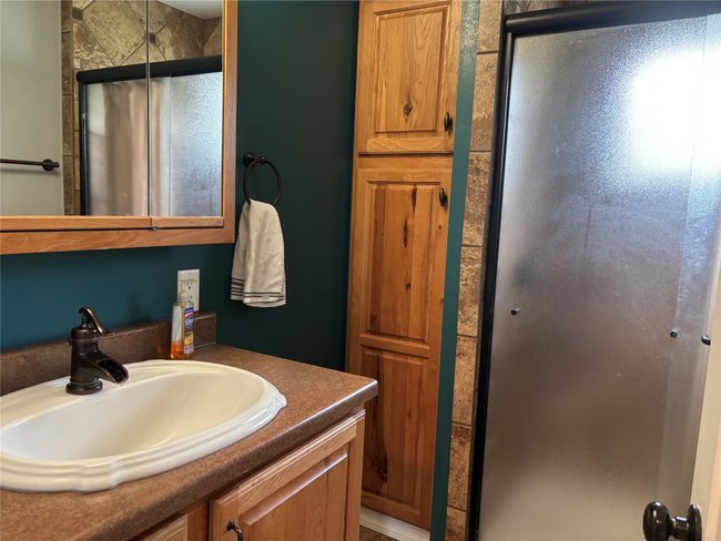Bathroom with a shower stall and vanity | Image 14