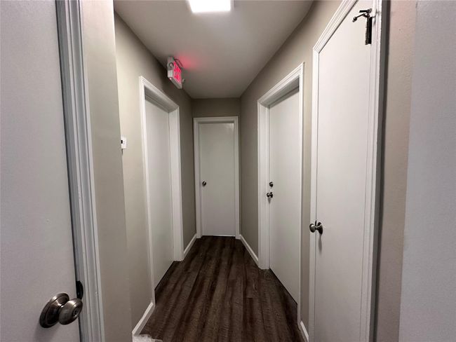 Hall with dark wood finished floors and baseboards | Image 21