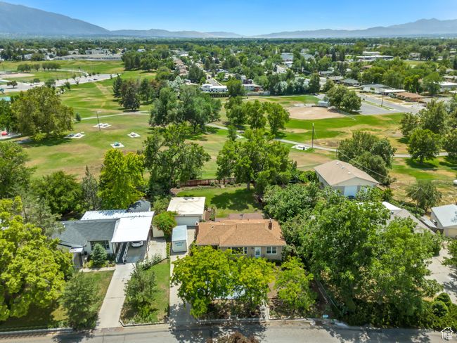 Aerial perspective of suburban area with a mountainous background and a golf course | Image 35