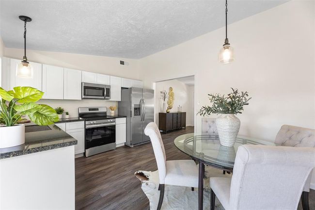 Fully renovated kitchen with sleek countertops and stainless steel appliances. | Image 10