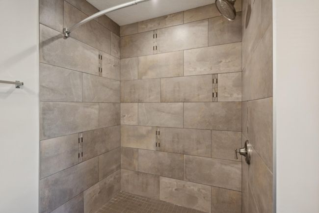 Spa-like... right?? This modern shower is fit for royalty! Again, floor-to-ceiling tile in this shower. We love this upgrade! | Image 29